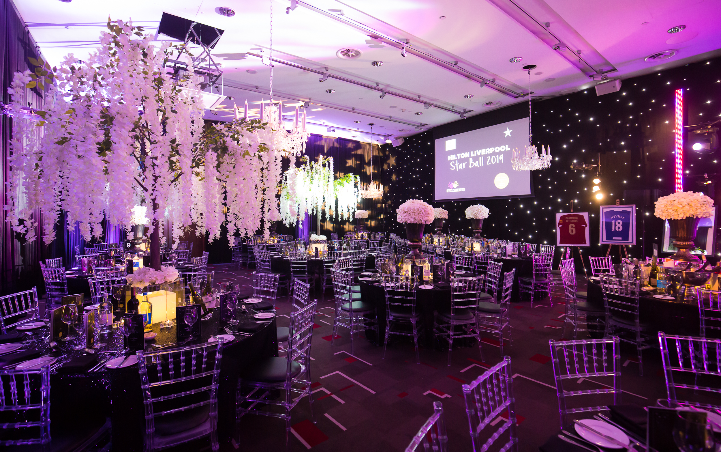 Grace Suite at Hilton Liverpool, elegant tables for a gala event with purple lighting. - Banner