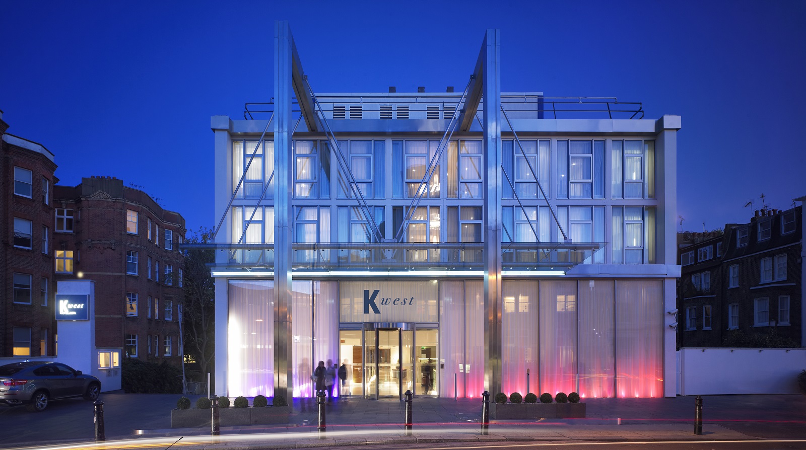 Modern event venue at K West Hotel with sleek glass facade, perfect for corporate meetings.