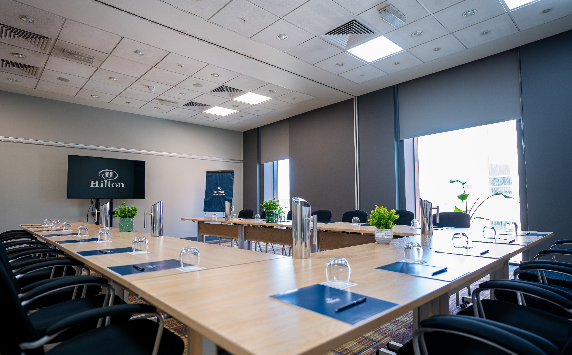 Meeting Rooms 1-10 at Hilton Deansgate, featuring a large table for corporate events.