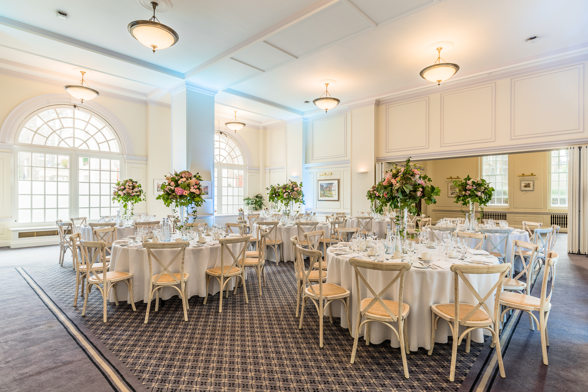 Elegant Snow Room at BMA House with floral centerpieces for weddings and corporate events.