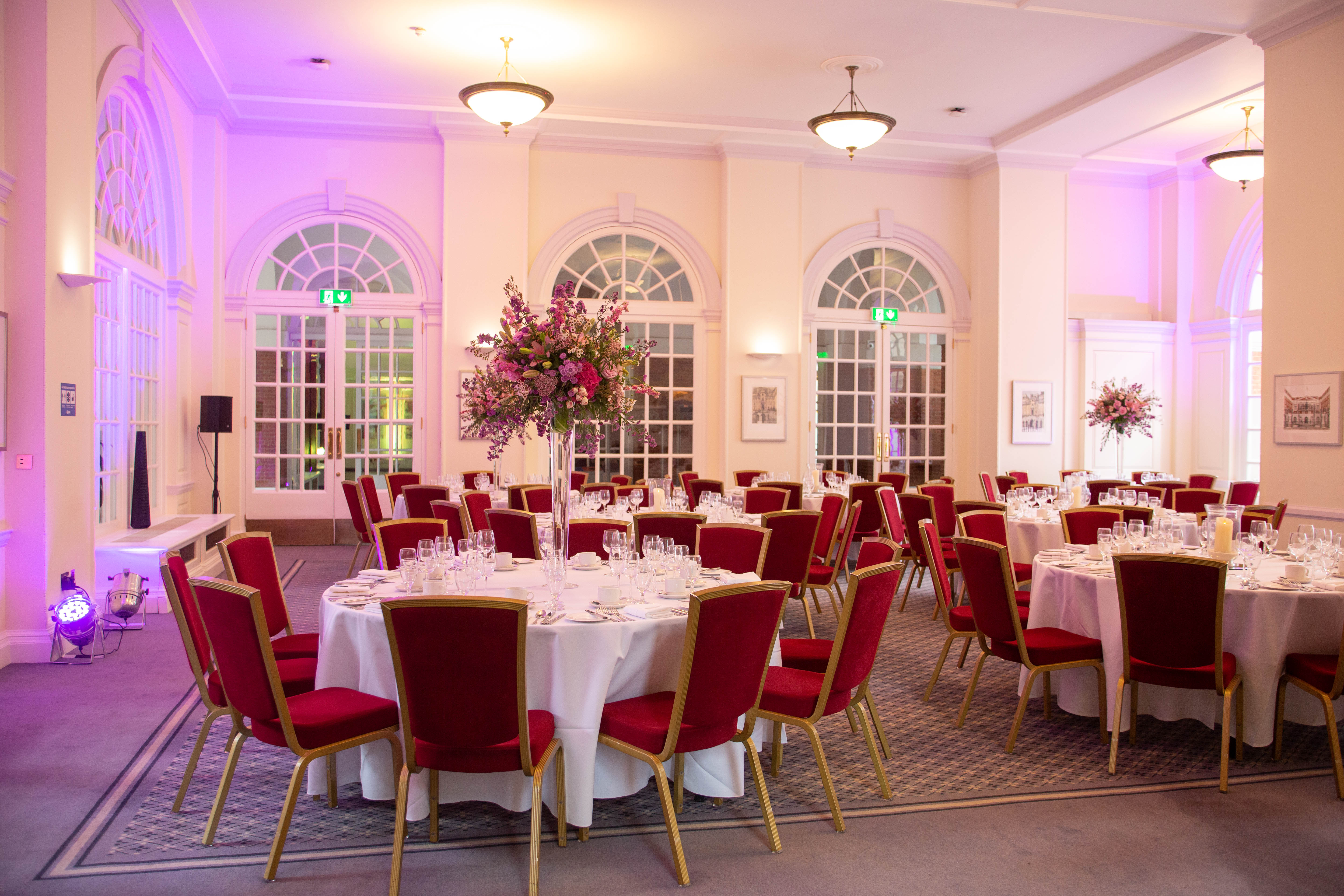 Elegant banquet room with round tables, ideal for weddings and corporate events.
