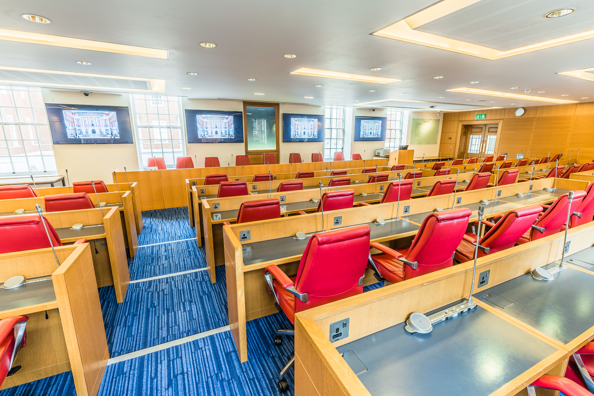 Modern conference room in BMA House with red ergonomic chairs for meetings and events.