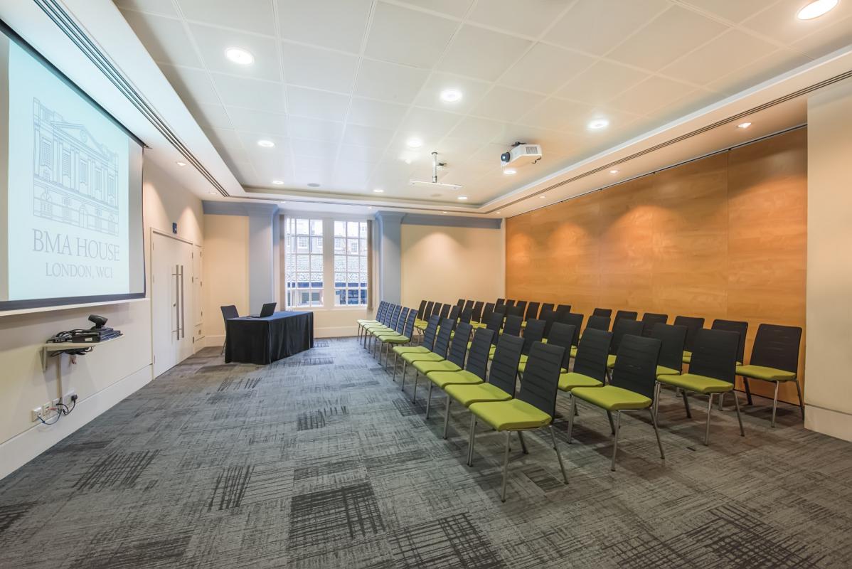 Murrell Barnes Suite: modern meeting room with projector, ideal for events and workshops.
