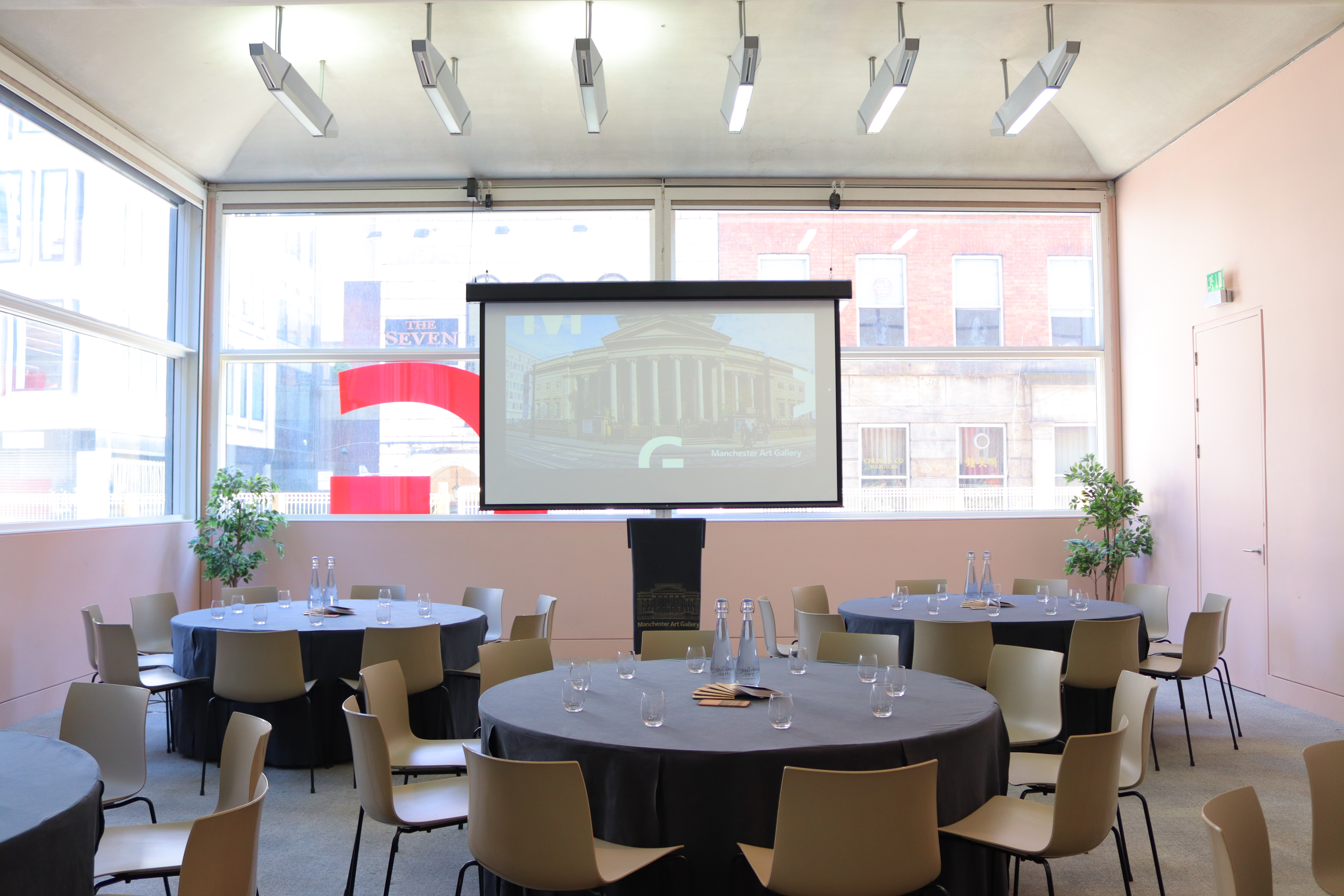 Lecture Room in Manchester Art Gallery with round tables, ideal for workshops and conferences.