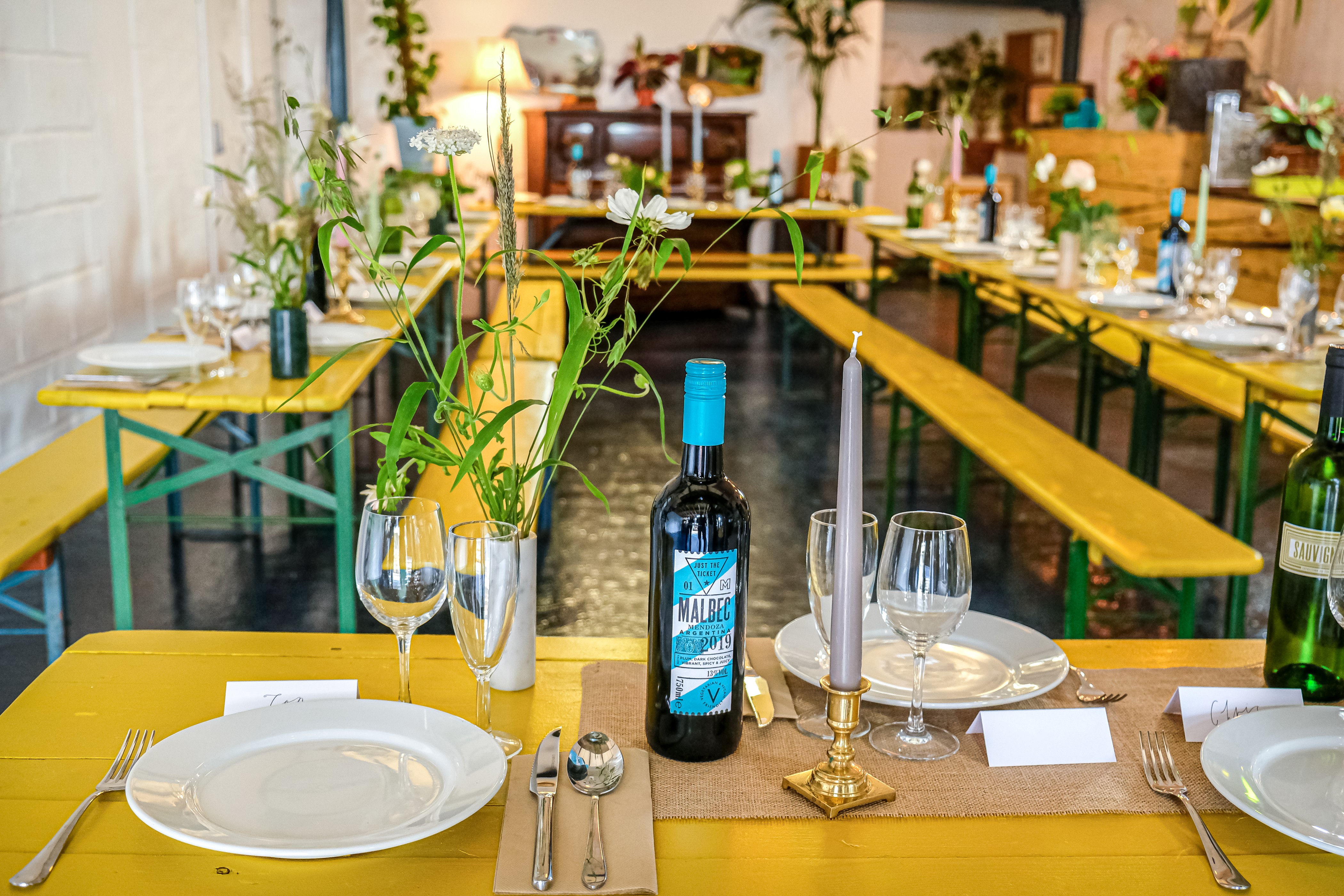 Homerton Venue dining setup with yellow tables for intimate events and gatherings.