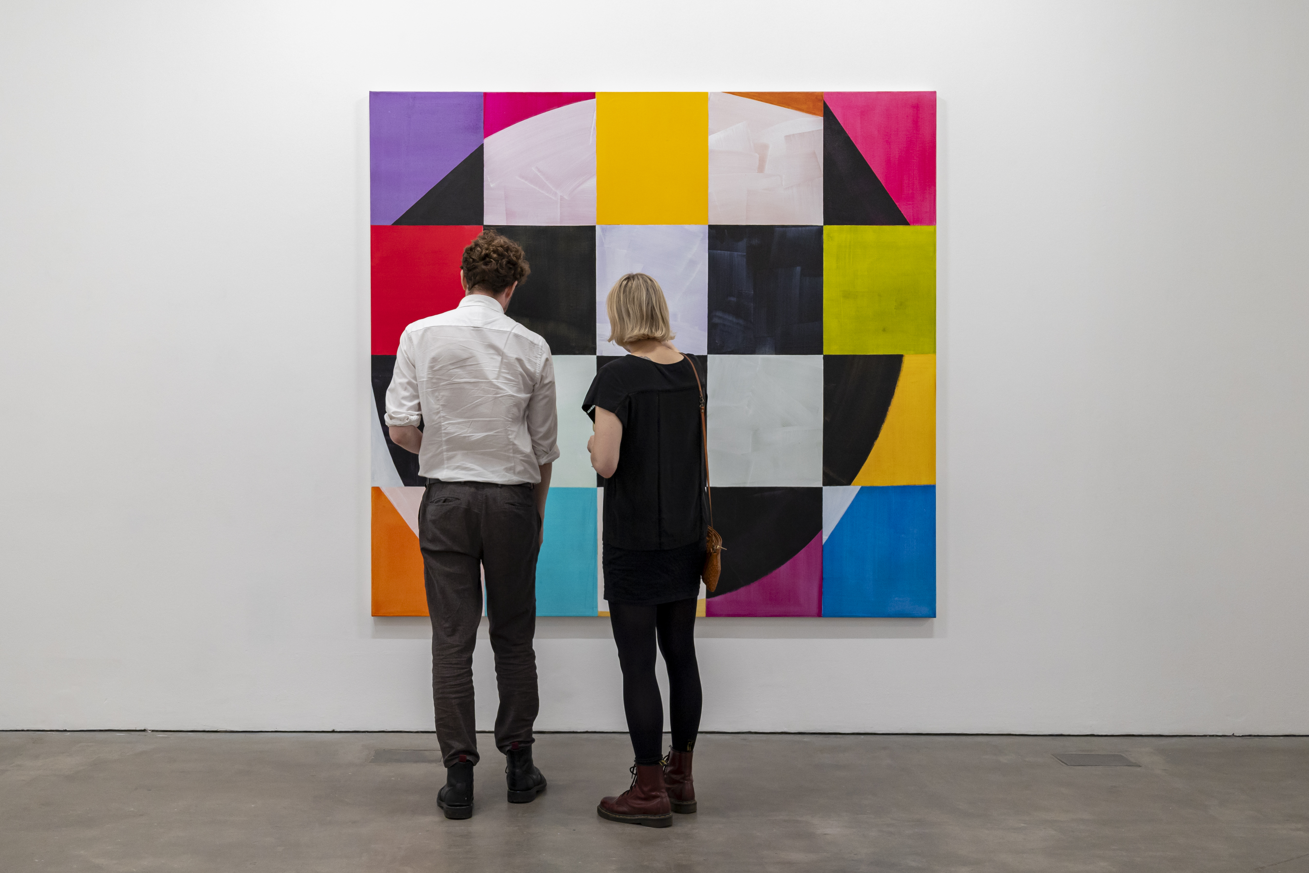 "Two people observing vibrant artwork at Ikon Gallery, enhancing networking and creativity."