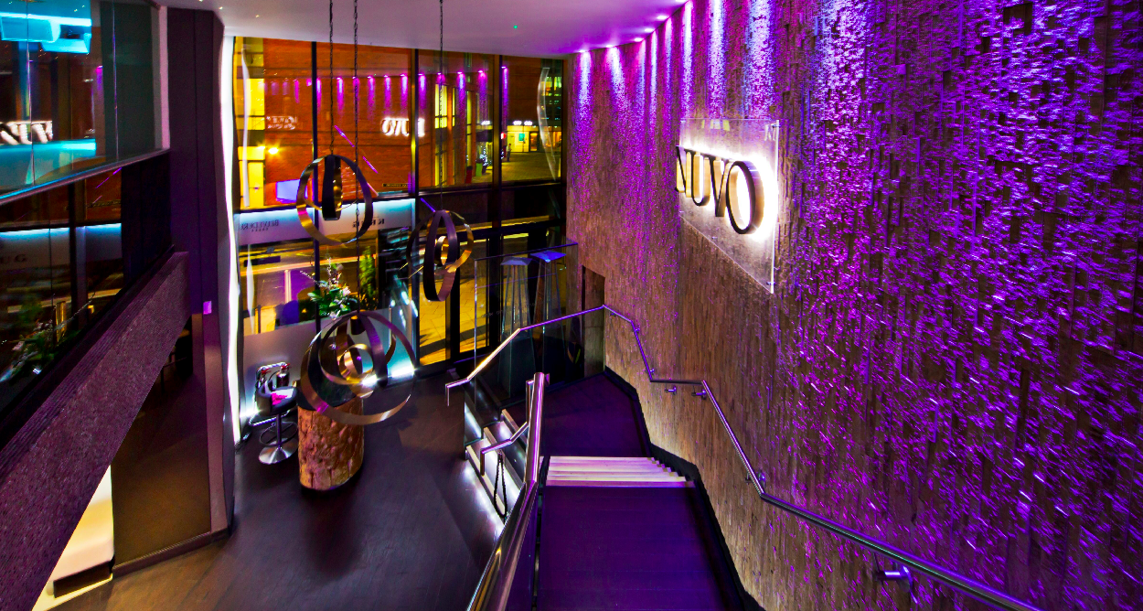 Modern event space with purple lighting, perfect for networking and celebrations.