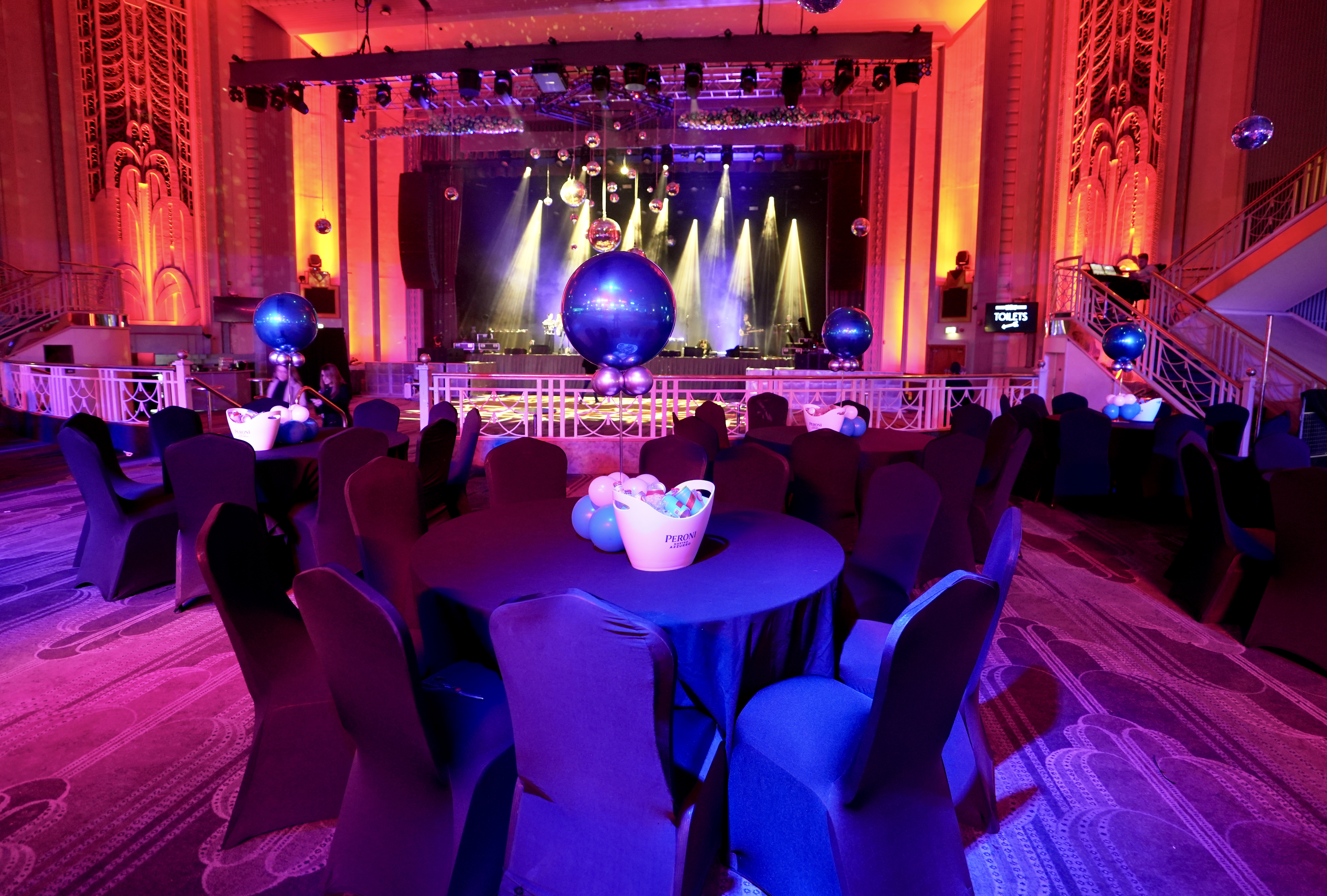 Christmas party gala at Troxy with elegant tables and a glamorous disco ball.
