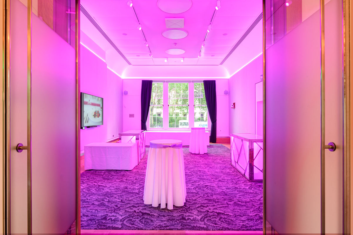 Sir Kirby Laing in modern event space with purple lighting for networking and receptions. - Banner