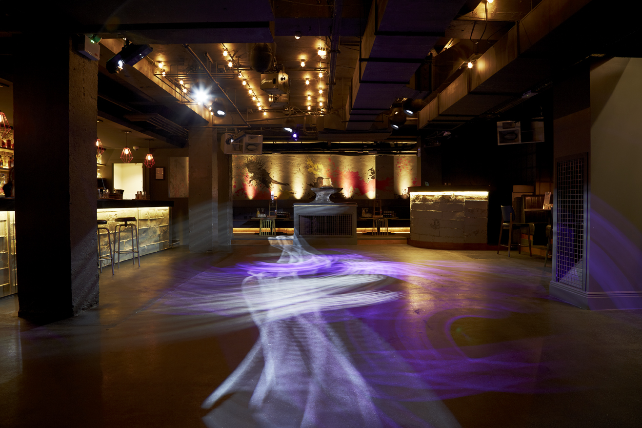 Versatile event space with ambient lighting, ideal for corporate gatherings and social events.