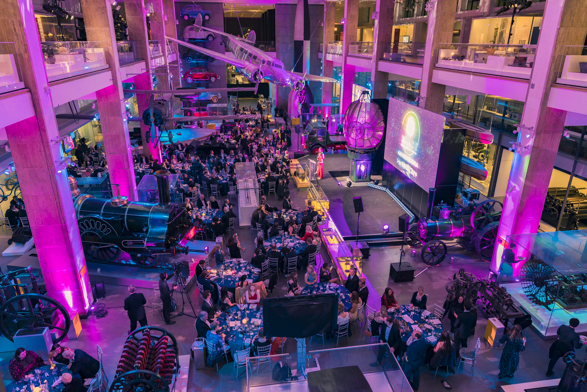 Vibrant event space at The Science Museum with dynamic purple lighting for networking celebration. - Banner
