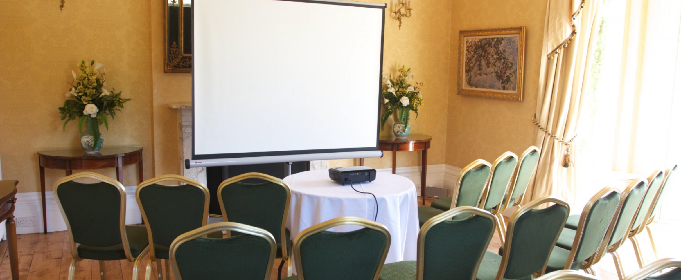 Exclusive Use meeting space with projector screen, ideal for presentations and workshops.