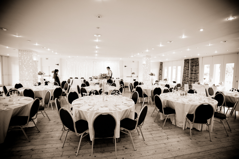 Elegant Britannia Suite event space with round tables, ideal for gatherings and celebrations.