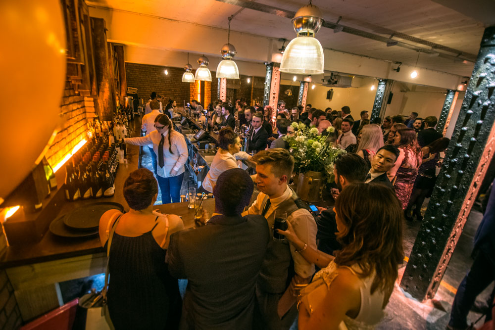 Vibrant networking event at The Bays, Victoria Warehouse with modern decor and warm lighting. - Banner