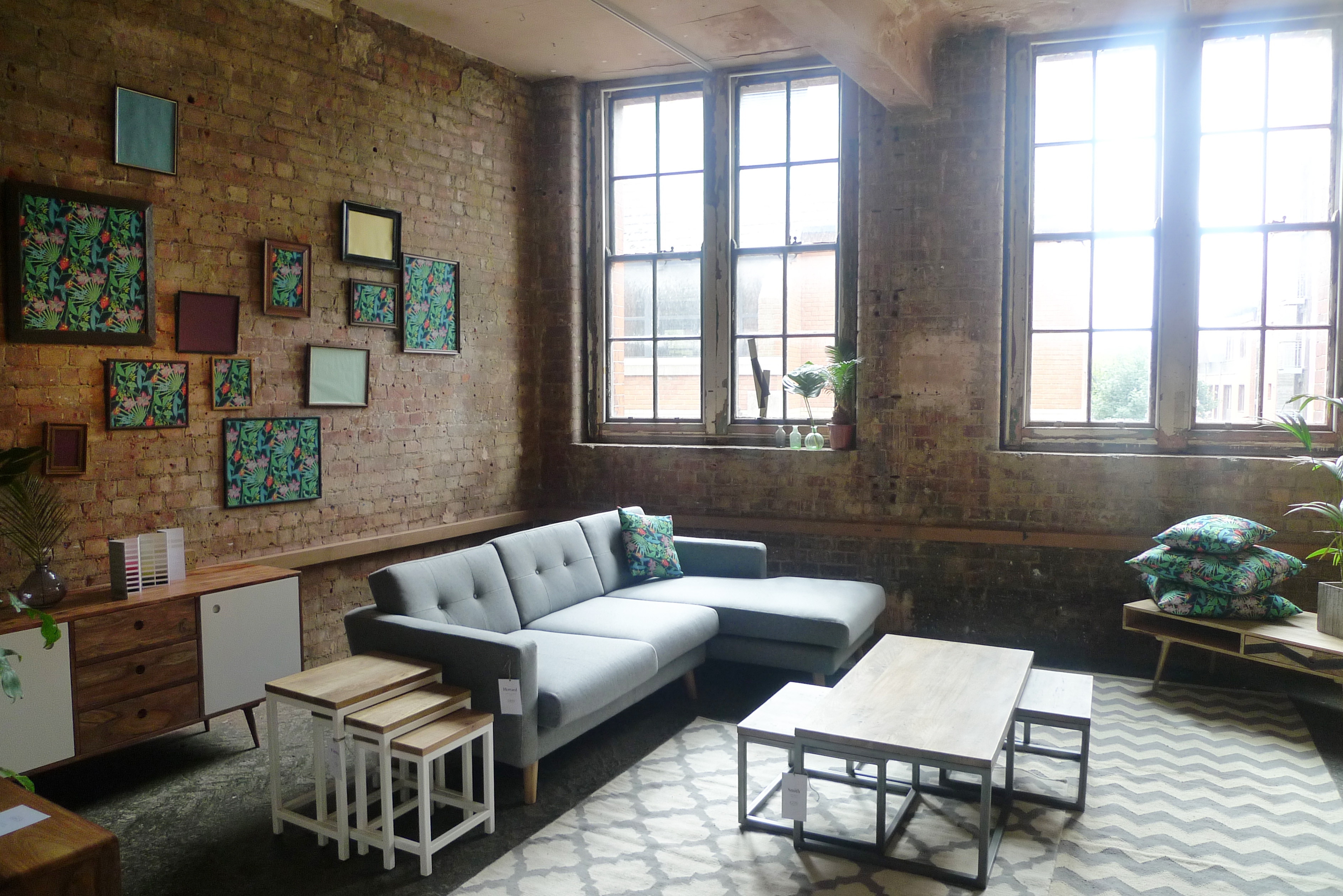 Stylish OXO Tower bar with gray sectional sofa, ideal for meetings and gatherings. - Banner