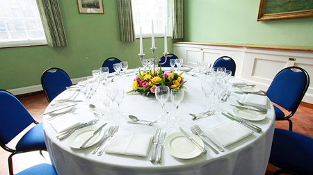 Elegant round table setup in London House for formal dinners and corporate events.