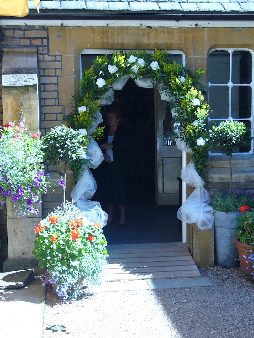 Elegant garden entrance with floral arrangements for weddings and special events.