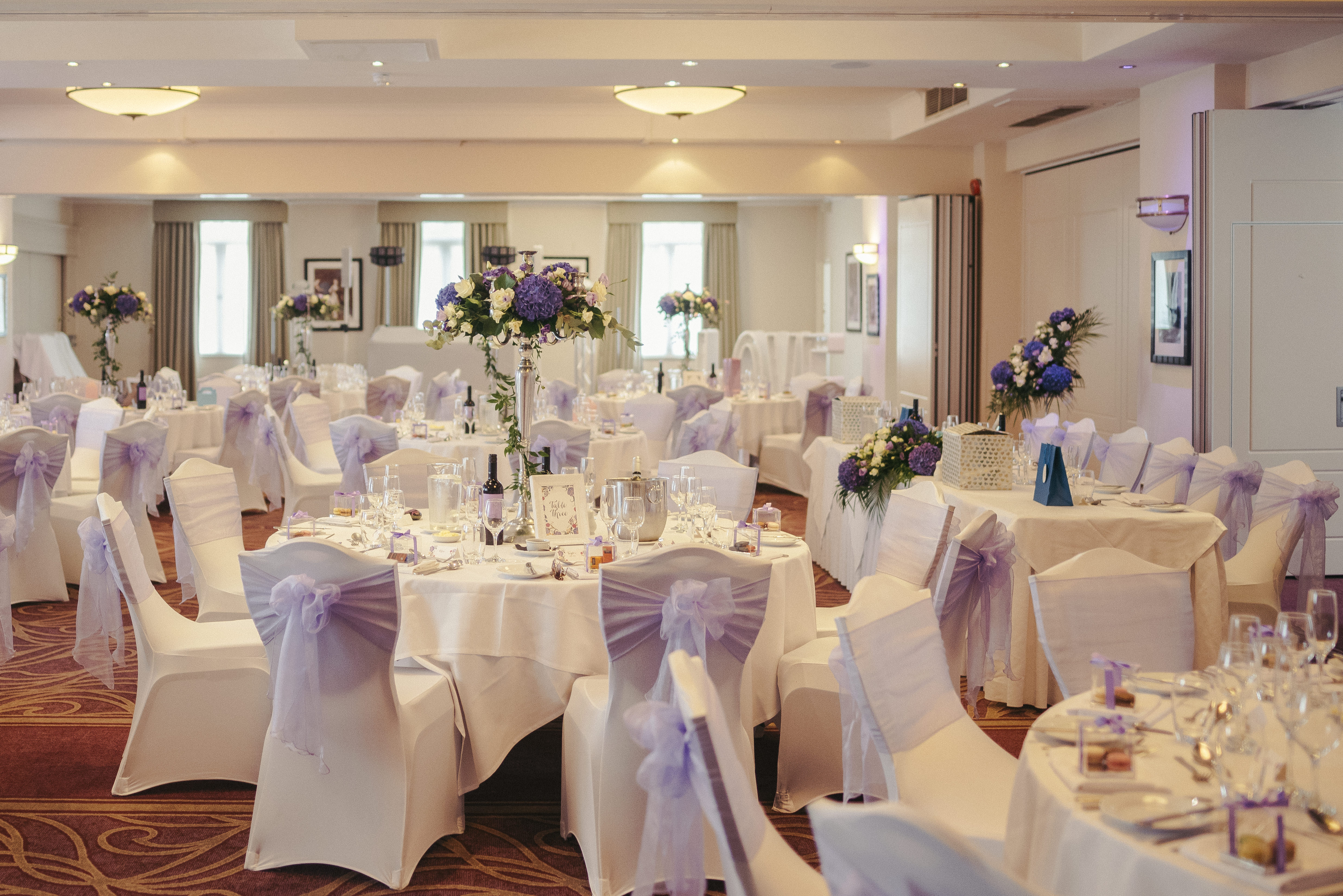 York Suite at Oatlands Park Hotel, elegant wedding venue with floral centerpieces.