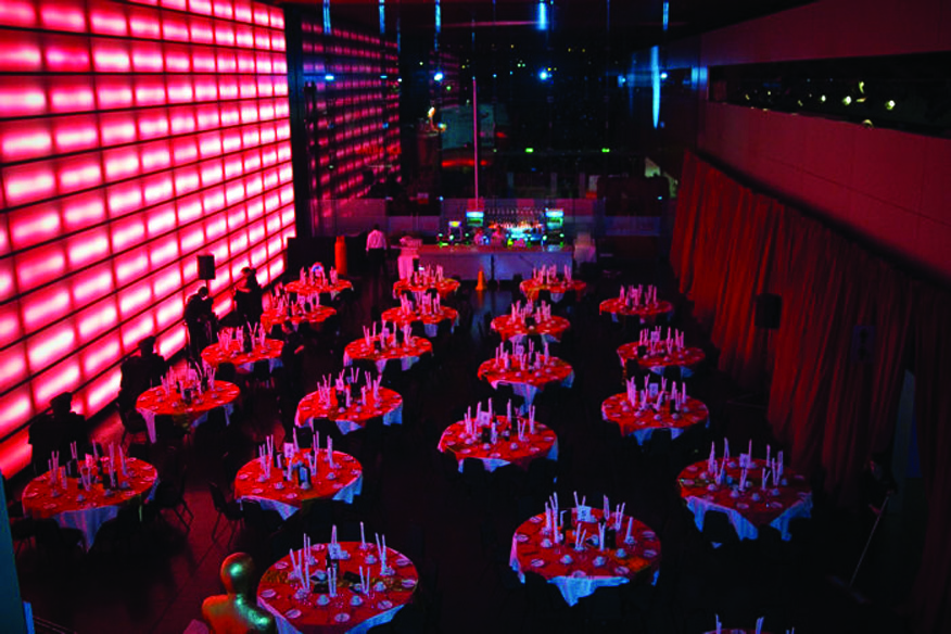 Elegant Red Hall event space with round tables, ideal for social gatherings and corporate events.