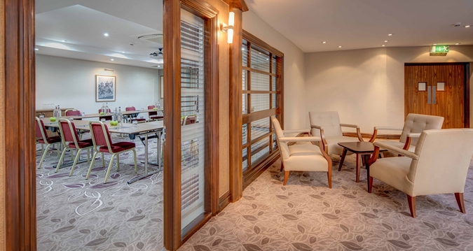 Tennyson suite at Hilton Cambridge: stylish meeting space with plush seating for events.