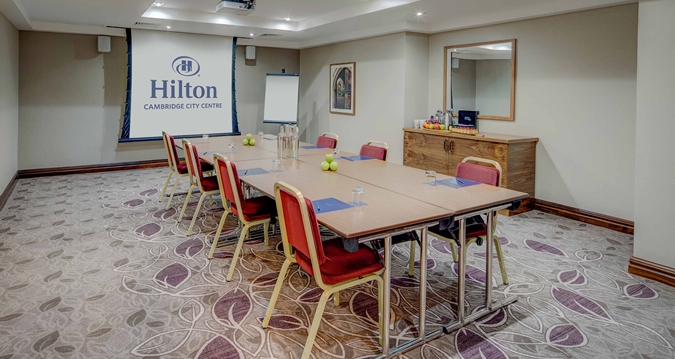 Wordsworth suite meeting room at Hilton Cambridge, ideal for corporate events with natural light.