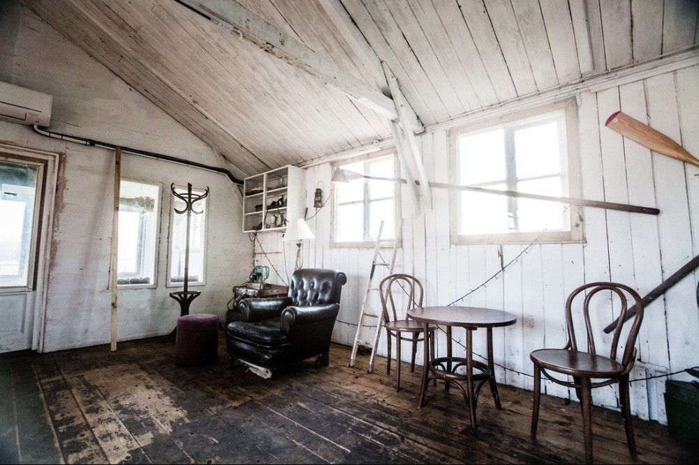 Cozy rustic meeting space at The Shack, Osea Island, perfect for creative workshops.