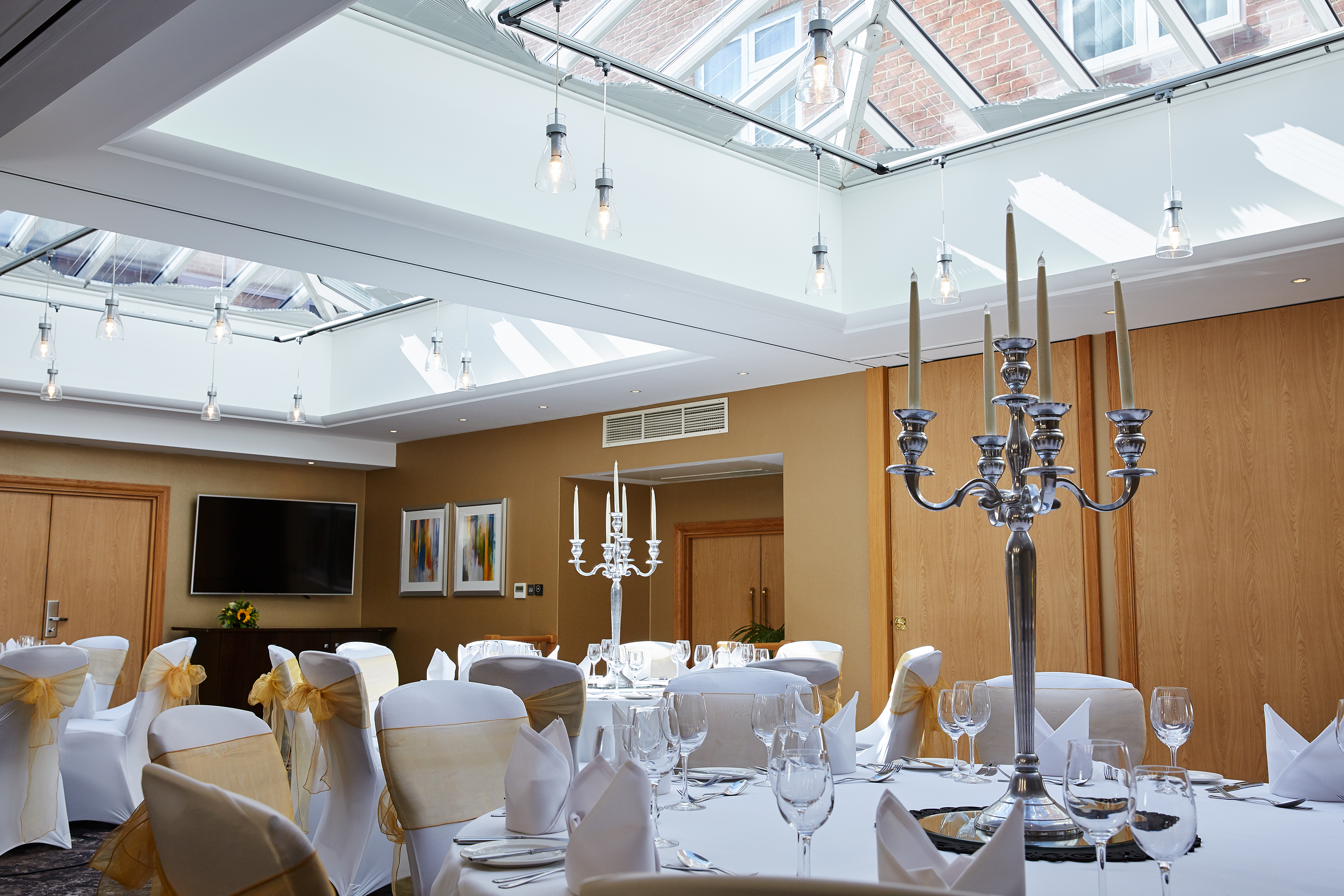 Buckingham Suite at The Bull Hotel, elegant event space with round tables and candelabra.