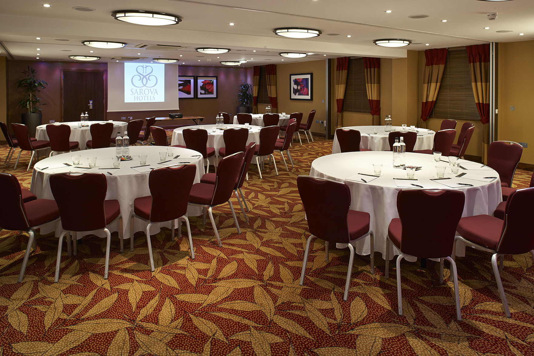 Chalfont Suite meeting space with round tables, ideal for workshops and networking events.