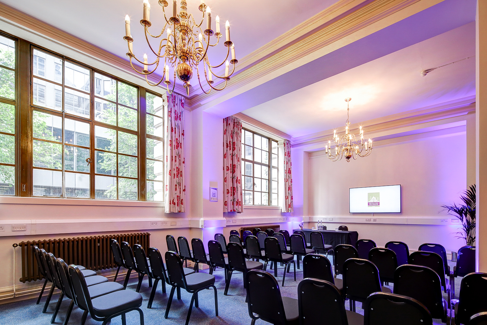 Maurice Barnett in a well-lit seminar room with elegant chandeliers at Central Hall Westminster.