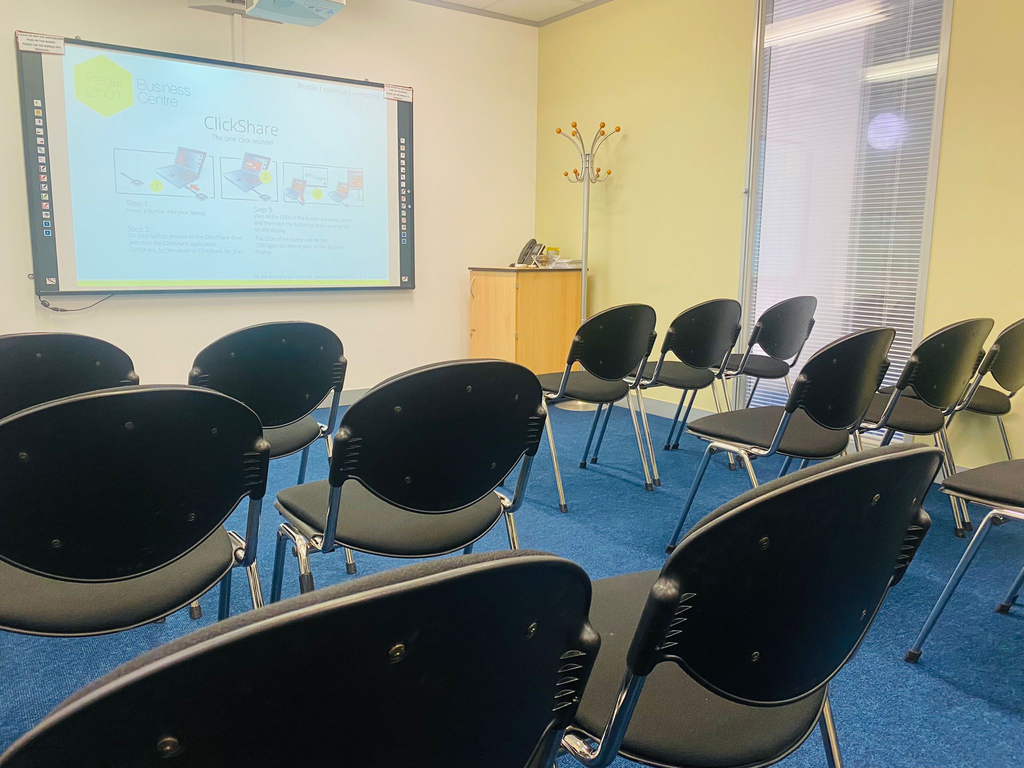 Picasso meeting space with black chairs, ideal for workshops and small conferences.