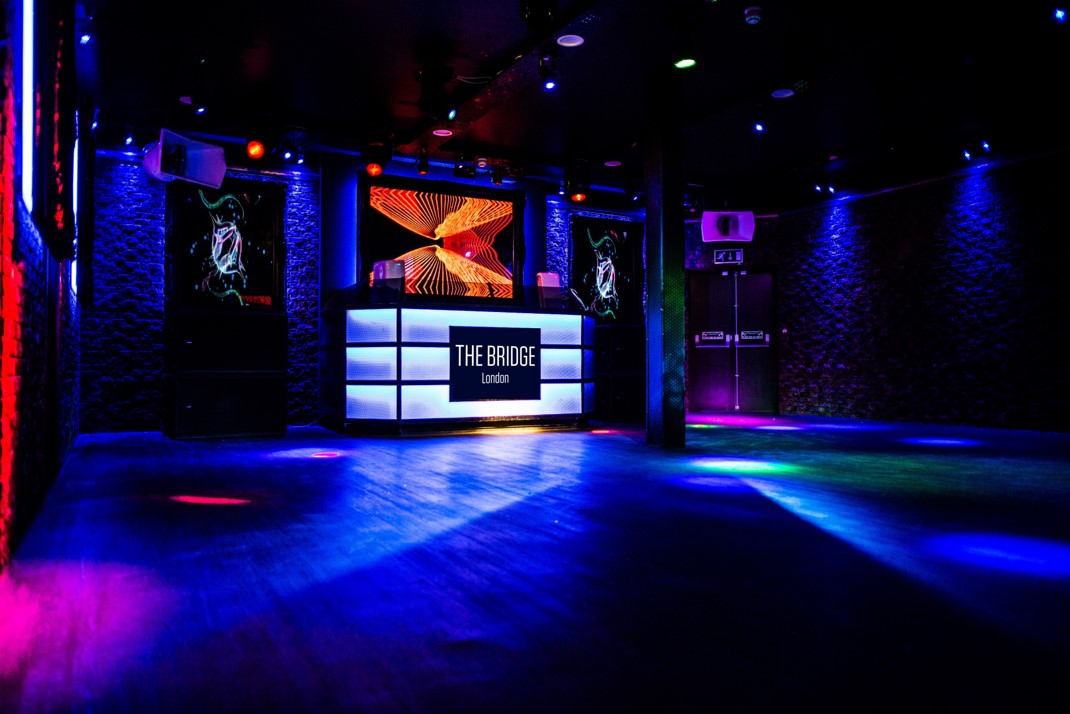 Vibrant event space at The Bridge London with dynamic lighting for nightlife gatherings. - Banner