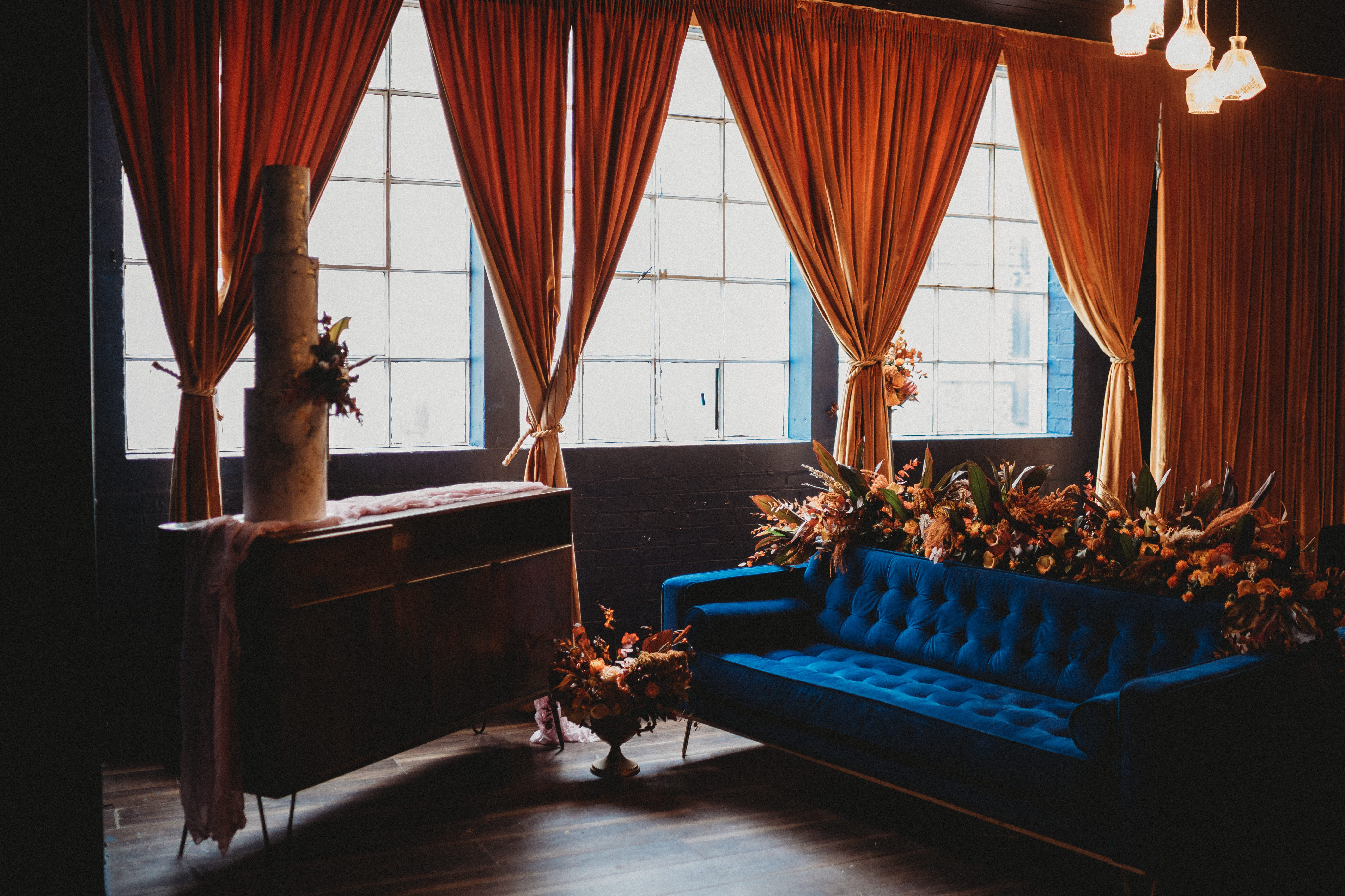 Stylish event space with blue sofa, ideal for networking and intimate gatherings.