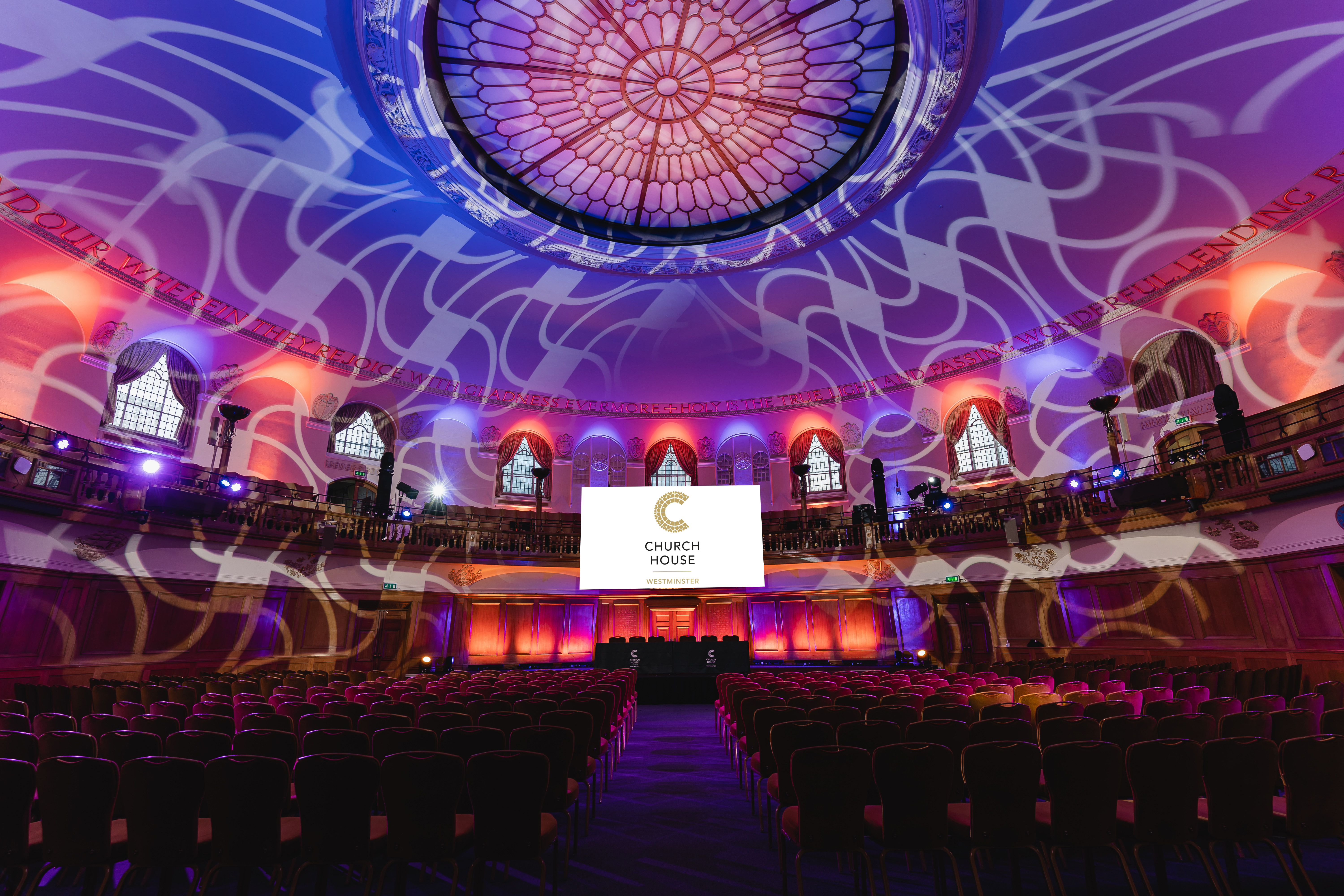 Assembly Hall in Church House Westminster with grand stained glass, ideal for events and presentations.