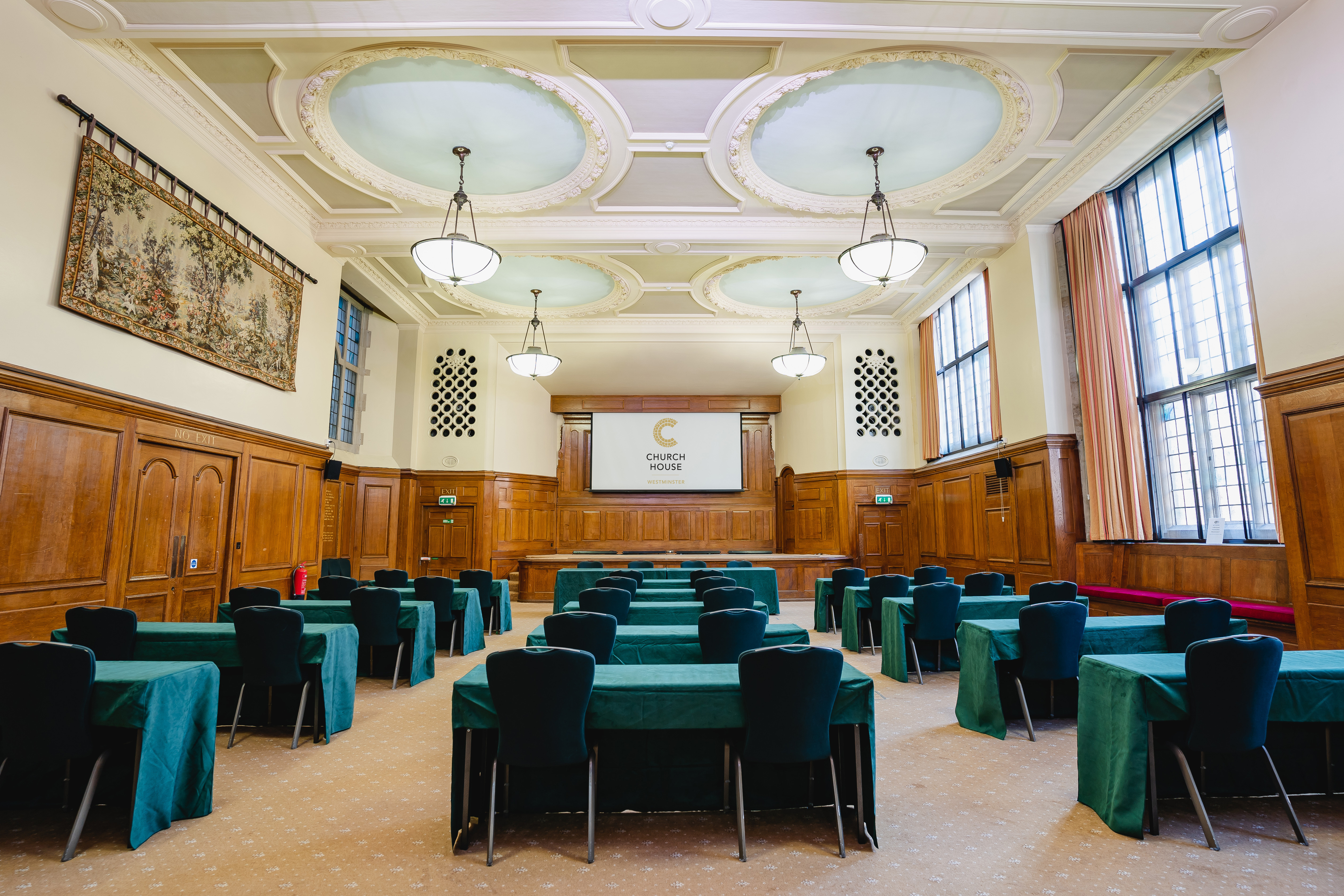 Hoare Memorial Hall: elegant meeting room with wooden paneling for corporate events.