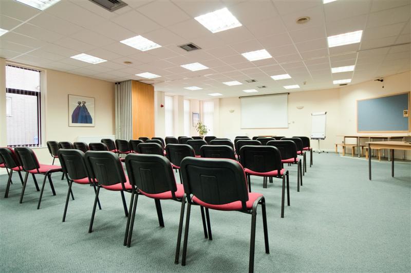 Seminar & Lounge at The Brain Charity, featuring black chairs for workshops and presentations.