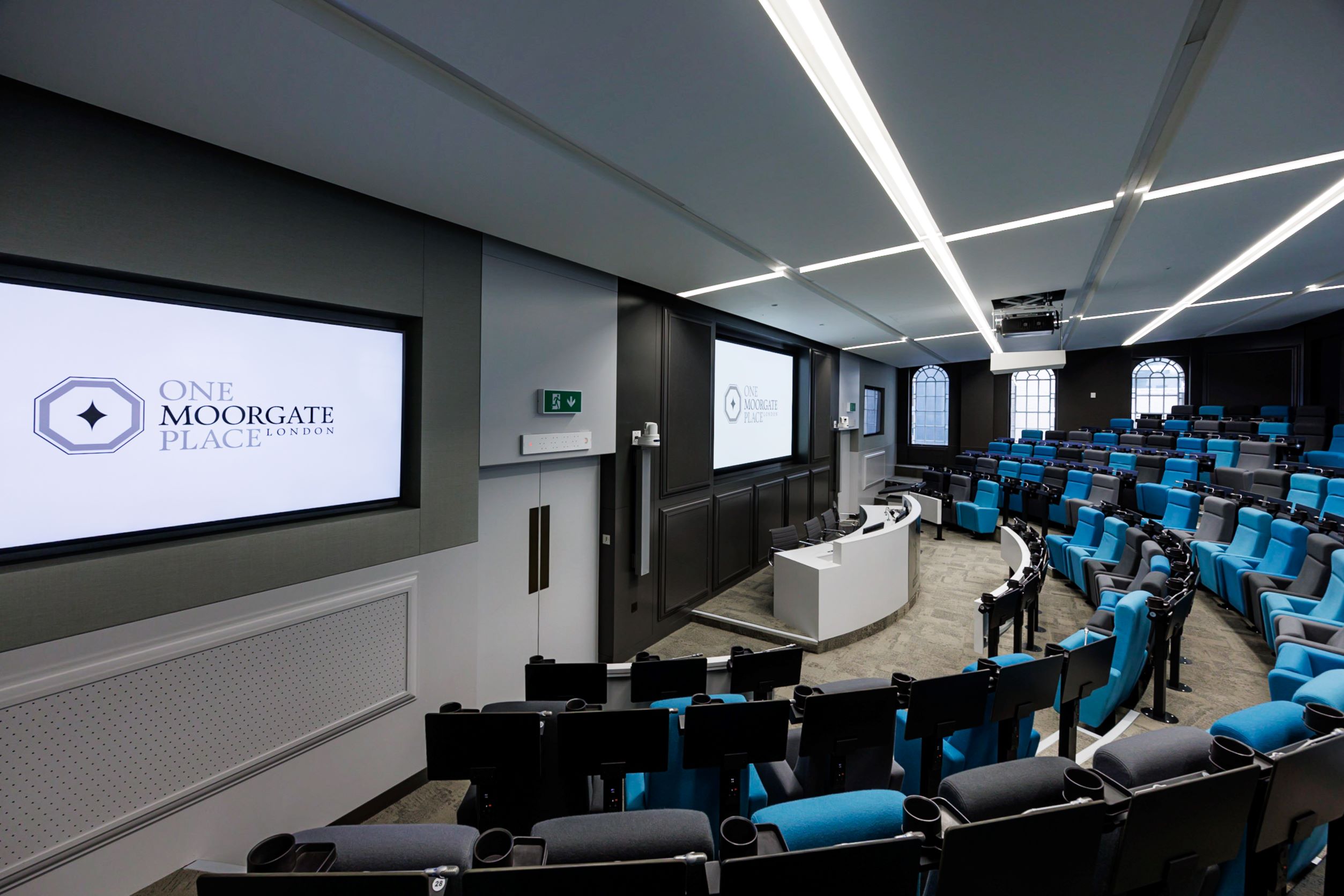 Modern conference room with tiered seating at One Moorgate Place for corporate events.