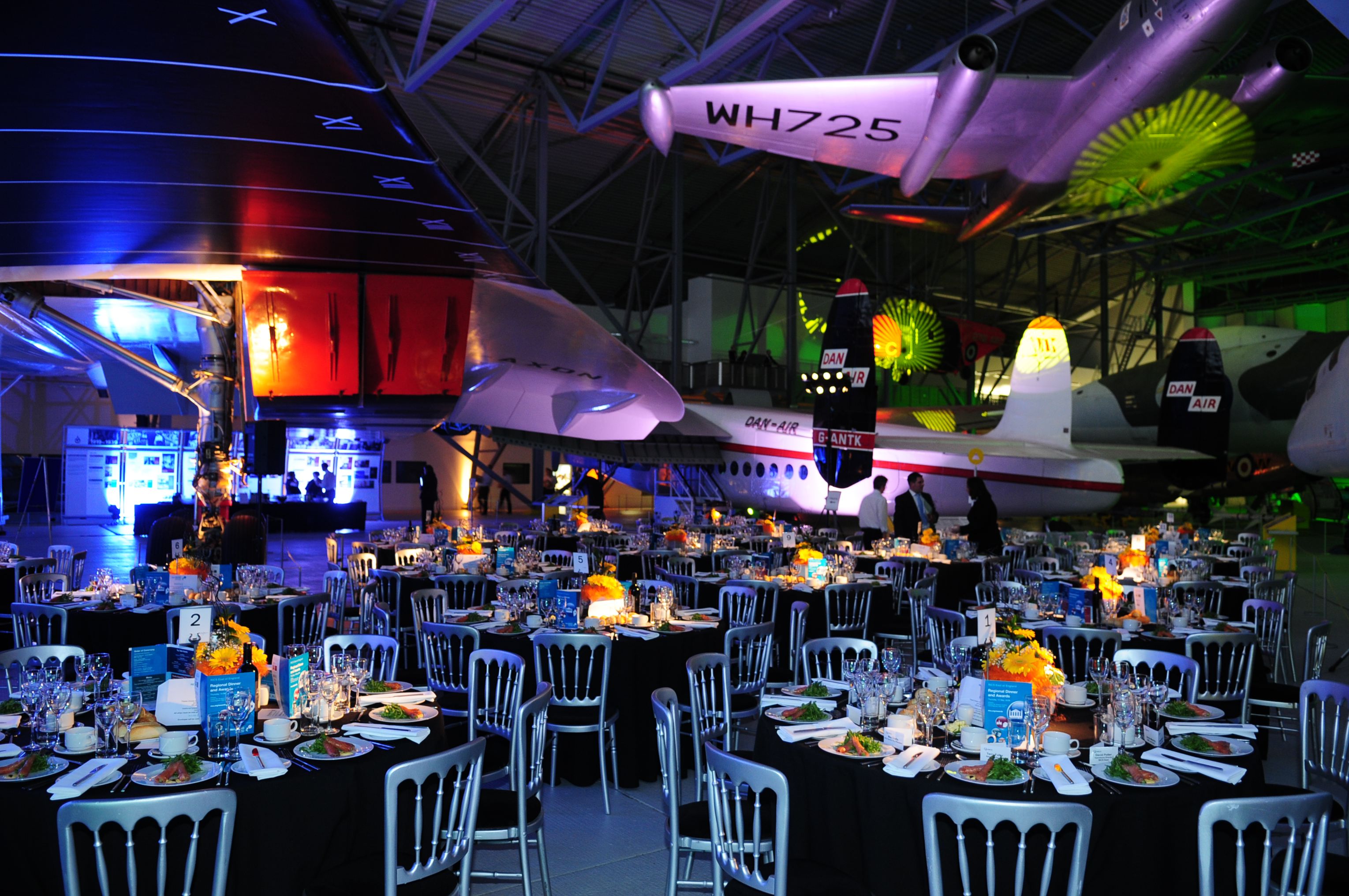 AirSpace Exhibition at IWM Duxford: elegant tables, vintage aircraft, corporate gala event.