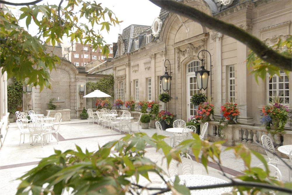 Elegant Dartmouth House courtyard with vibrant flowers, ideal for receptions and gatherings.