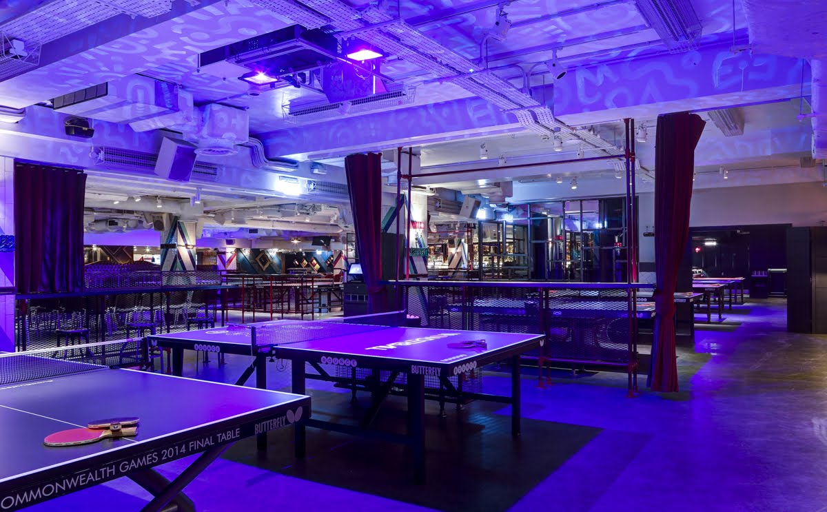 Versatile conference space with blue lighting, ideal for networking and team-building events.