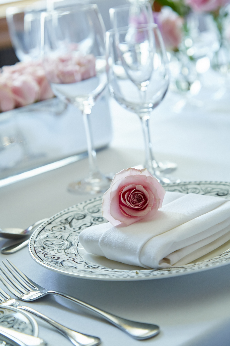 Elegant dining table with rose at London Marriott for upscale events and formal gatherings.