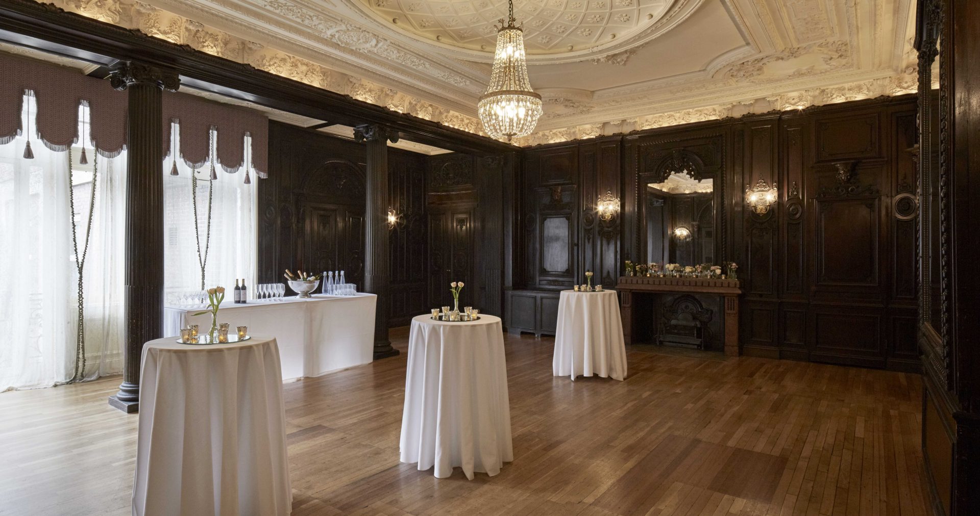 Elegant Churchill Room with dark wood paneling, ideal for upscale events and receptions.