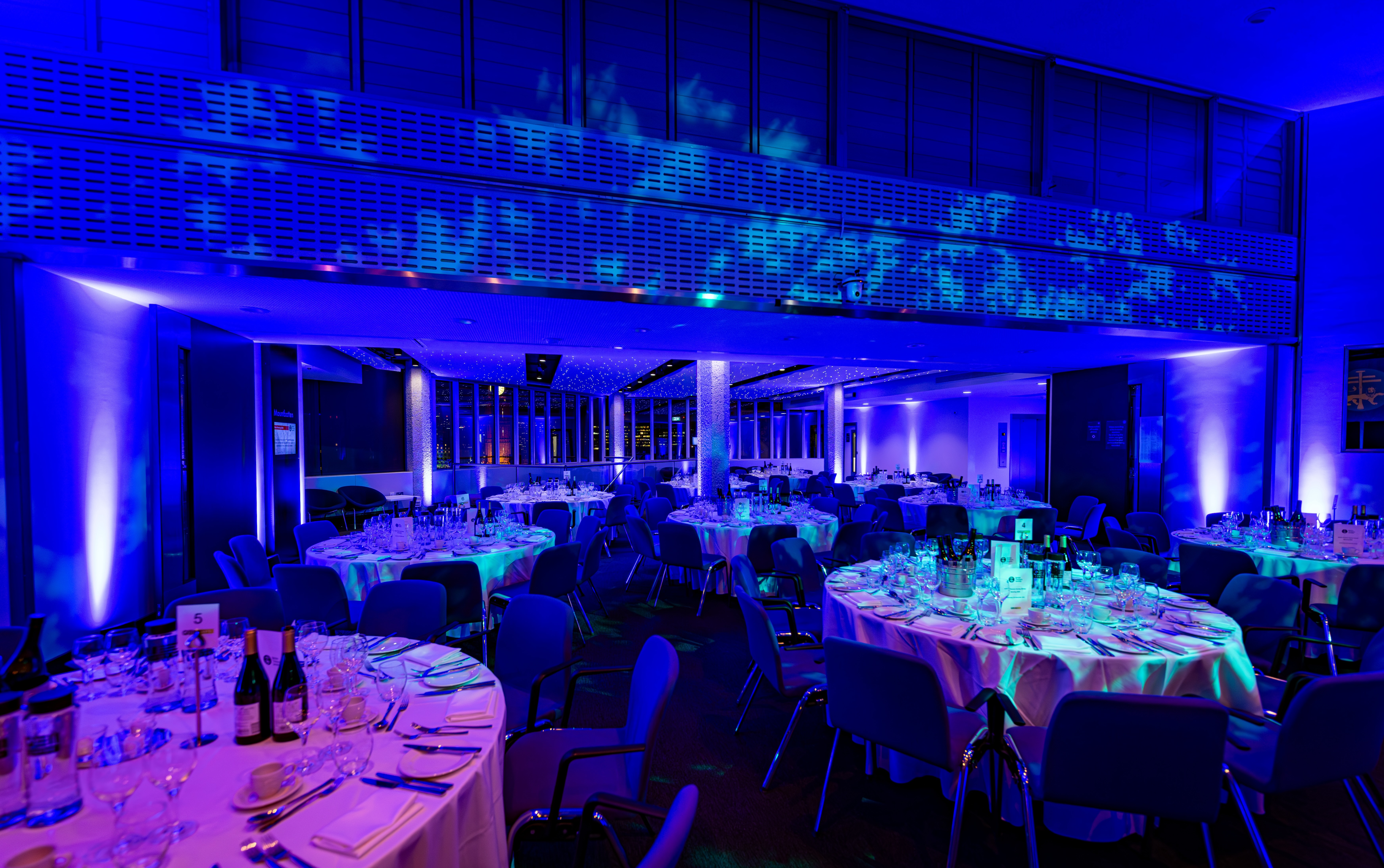 Mountbatten room banquet with blue LED lighting for corporate events and gala dinner setups.