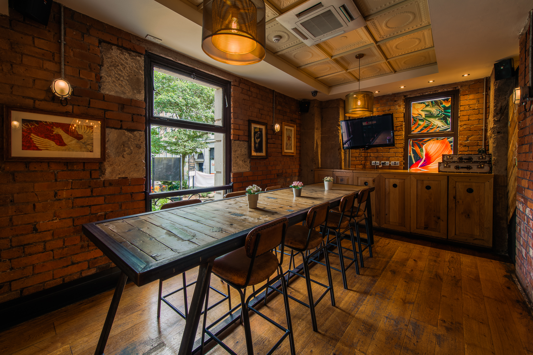Stylish meeting room with wooden table in Revolution Parsonage Gardens for events. - Banner