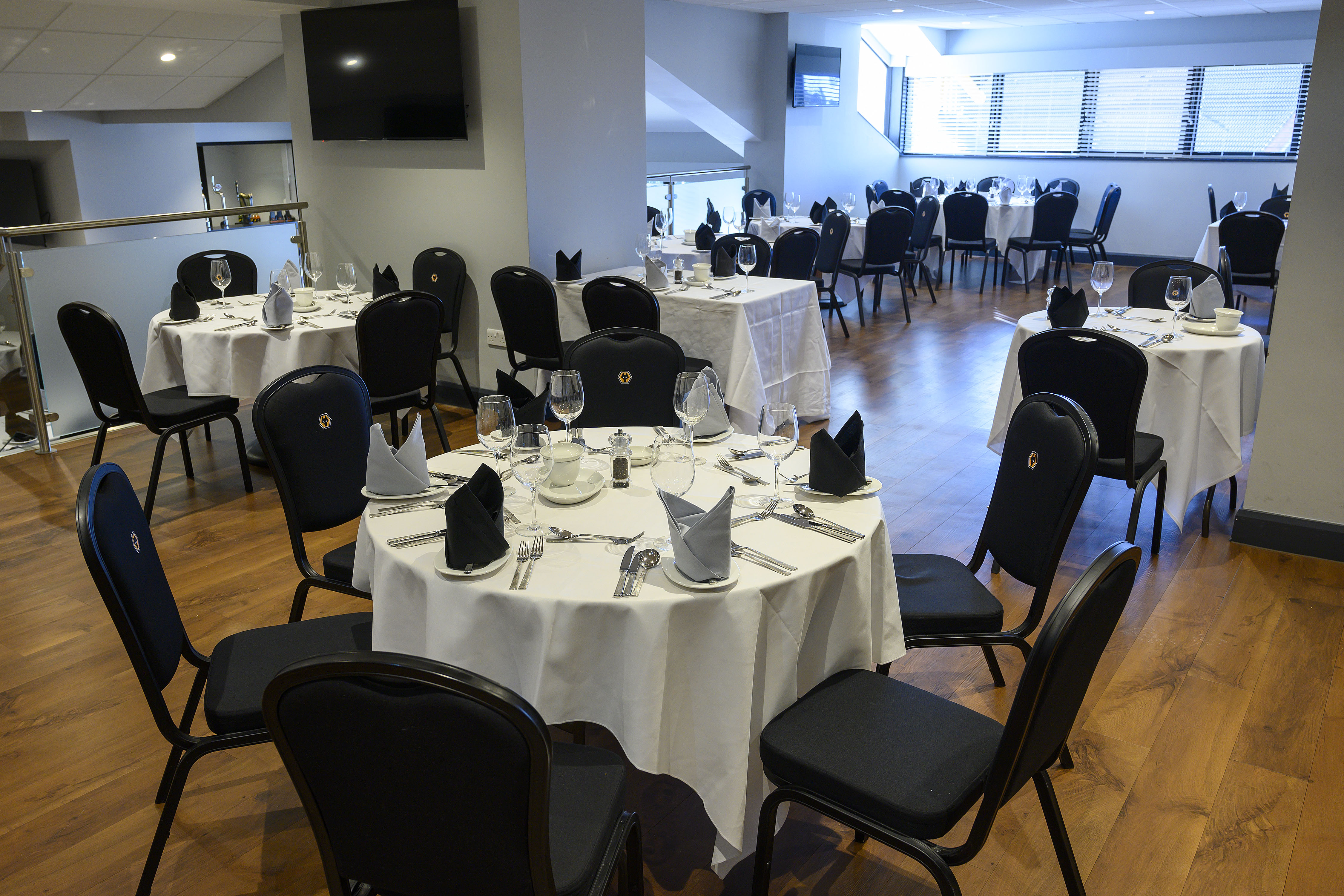 Boardroom at Molineux Stadium with elegant dining setup for corporate events and gatherings.