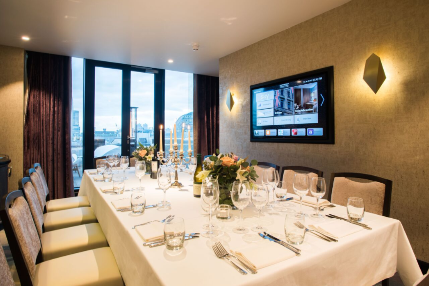 Elegant Palm Rooms meeting space with fine dining setup for corporate events.