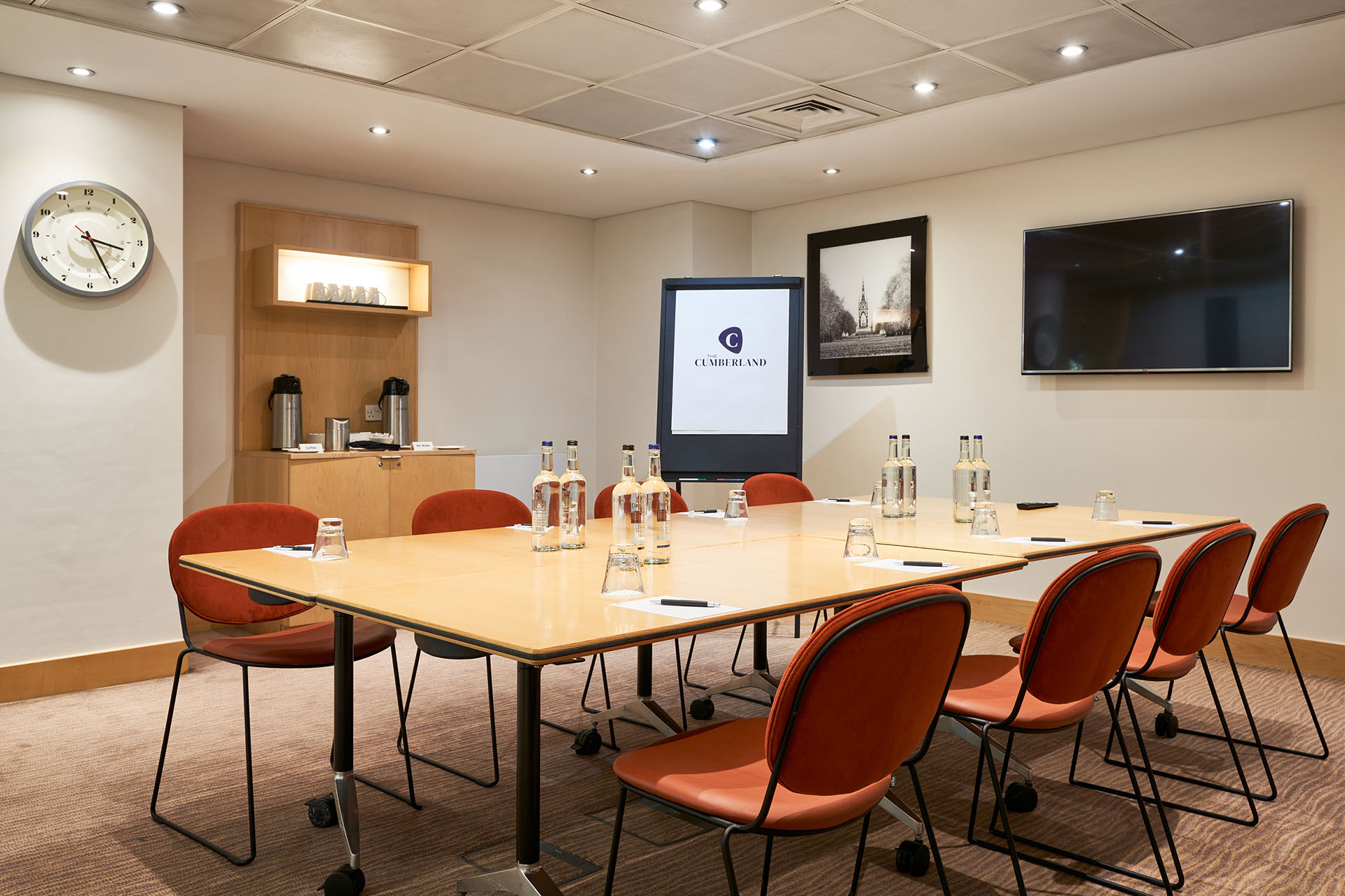 Meeting room in The Cumberland Hotel with large table and presentation technology.