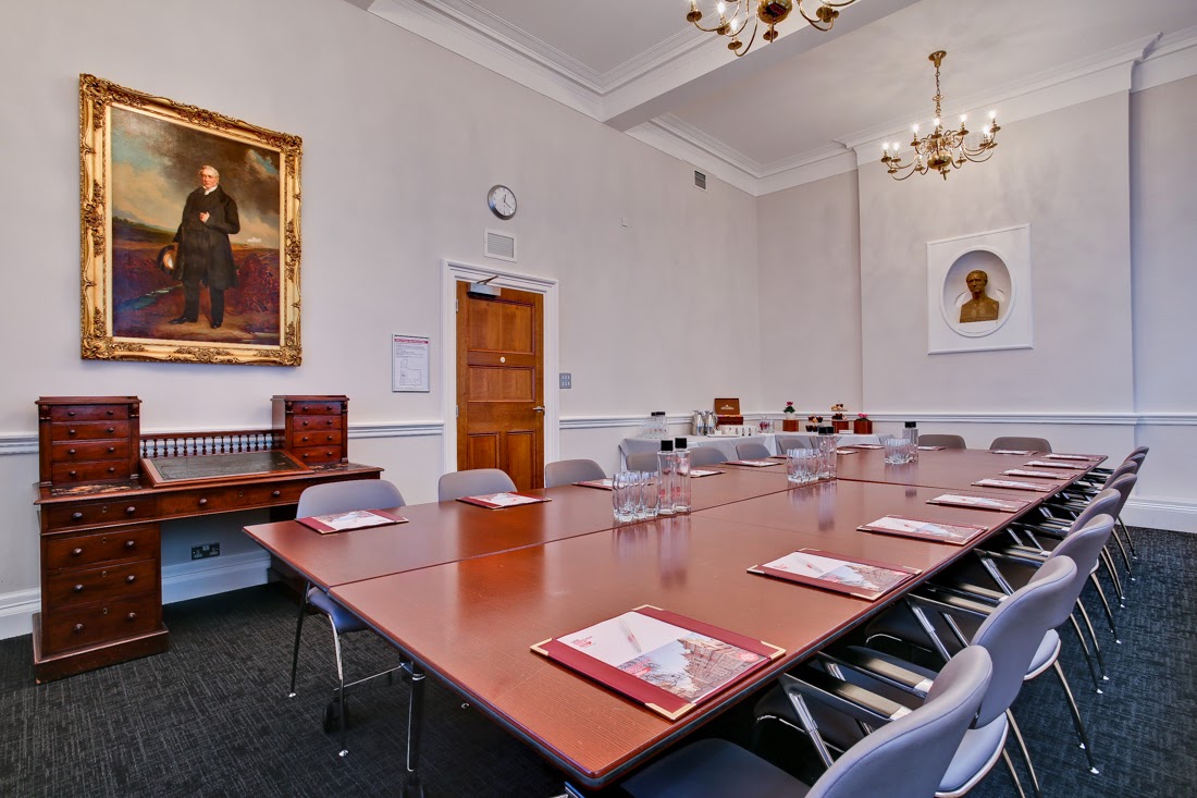 Elegant meeting room with long table, ideal for board meetings and strategic planning.