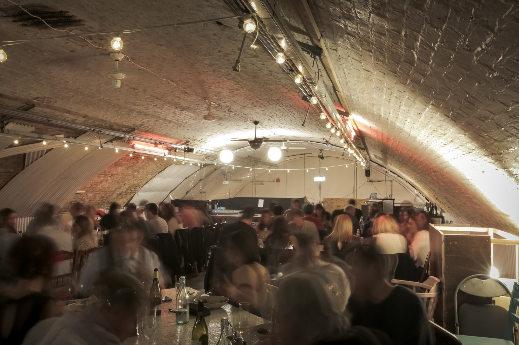 Lively event space with arched ceiling, perfect for networking and social gatherings.