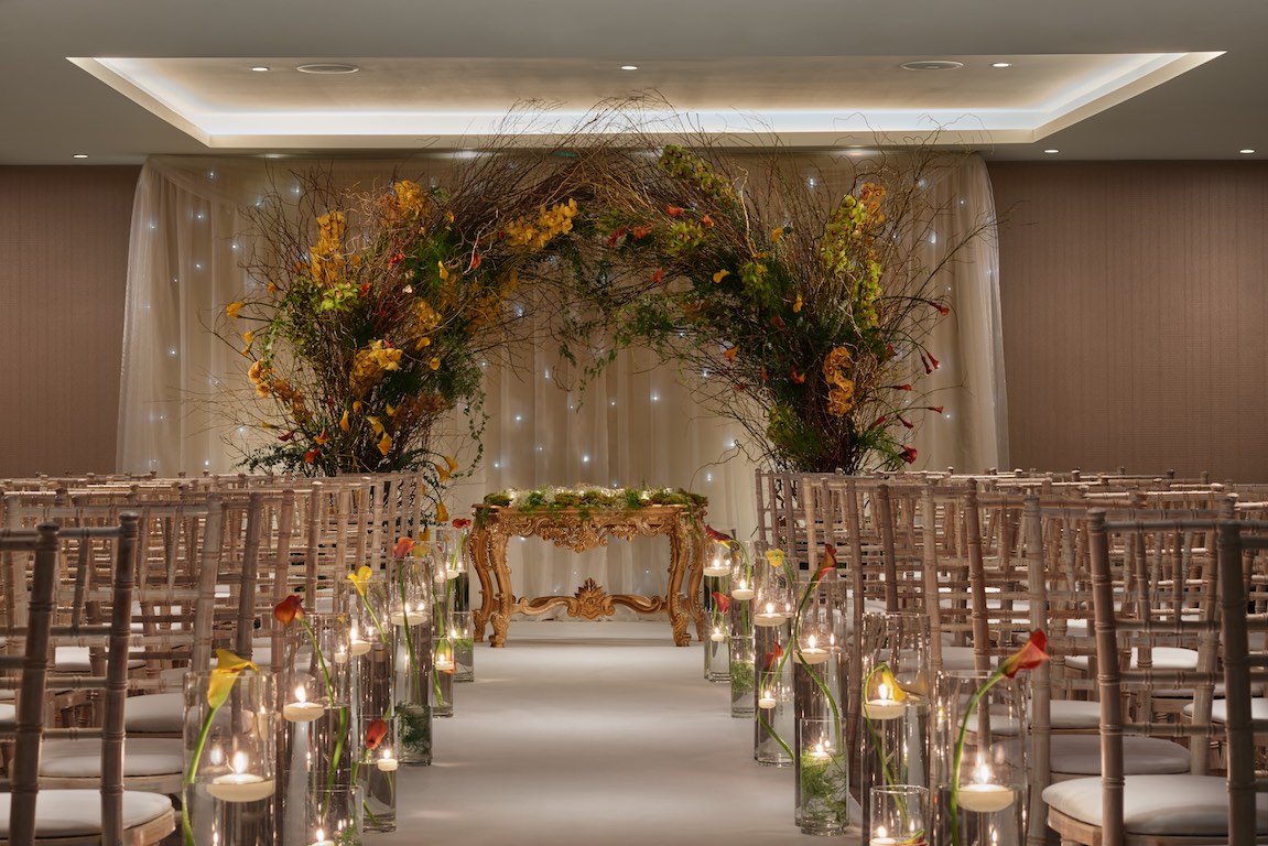 Elegant ceremony space with floral arch at Hilton London Bankside for weddings.