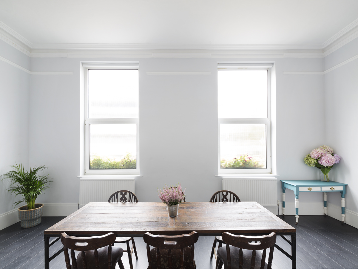 Bright minimalist meeting space with wooden table, ideal for workshops and discussions.